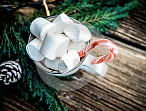 hot Christmas drink with marshmallow on wooden table