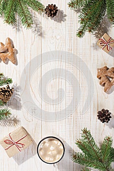 Hot Christmas drink with marshmallows in an iron mug and gingerbread cookies, on a white table. New Year, holiday background,