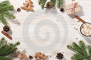 Hot Christmas drink with marshmallows in an iron mug and gingerbread cookies, on a white table. New Year, holiday background,