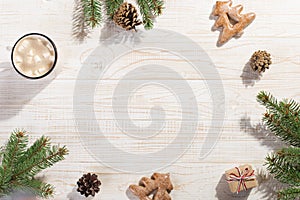 Hot Christmas drink with marshmallows in an iron mug and gingerbread cookies, on a white table. New Year, holiday background,