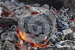 Hot coals and burning woods in the form of human heart. Glowing and flaming charcoal, bright red fire and ash. .Close-up