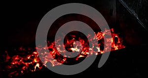 hot coals smolder. Beautiful red coals of a fireplace.