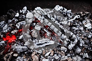 Hot coals texture, close-up. BBQ grill embers, top view
