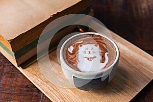 Hot cocoa cup topping cat shape with old books
