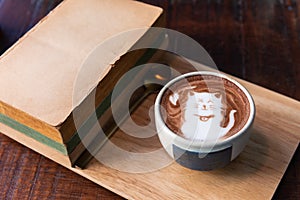 Hot cocoa cup topping cat shape with old books