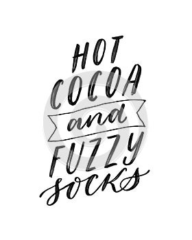 Hot cocoa and fuzzy socks. Hand written lettering quote. Cozy phrase for winter or autumn time. Modern calligraphy