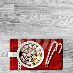 Hot Cocoa with Marshmallows on Red Towel with Candy Canes Copyspace