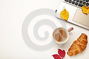 Hot coffee and autumn leaves with notebook on white - seasonal relax concept