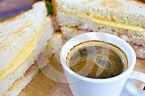 Hot coffee with big sandwiches for breakfast.