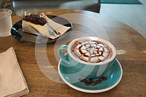 Hot coffee with blueberry cheesecake in green cup and saucer