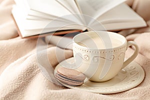 Hot coffee and book on wool background - seasonal relax concept