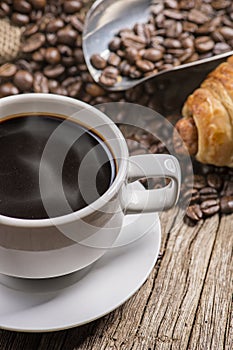 Hot coffee and bread on wooden background