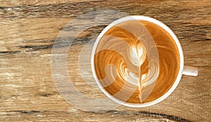 Hot coffee cappuccino latte art top view on wooden background