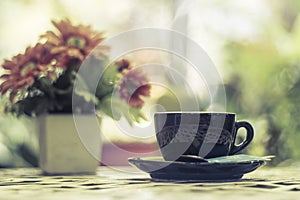 Hot coffee in the cup on morning background.