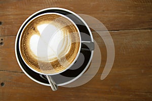 Hot coffee cup top view on wooden table background