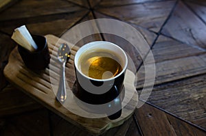 Hot coffee cup  top on wooden with coffee shop.