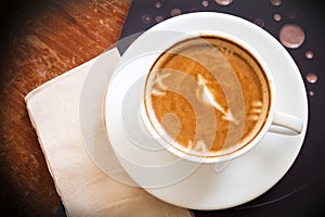 Hot coffee cup on wooden table. Top view.