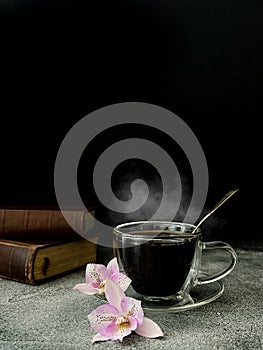 Hot coffee drink with flowers and books in the background