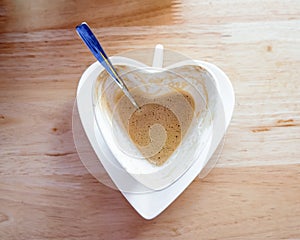 Hot coffee fade and spoon in white heart cup