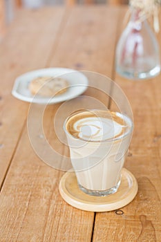 Hot coffee in a glass cup retro style placing on the wooden table