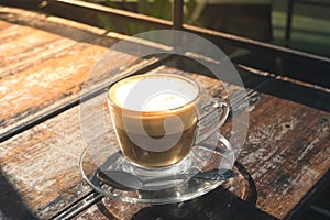 Hot coffee in glass cup on table