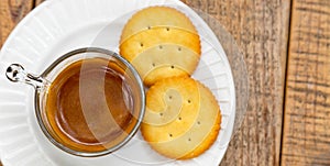 Hot coffee in glass placed on the table with cookies.