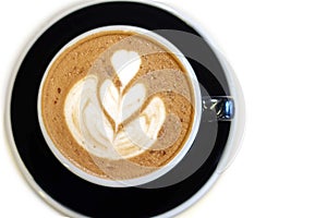 Hot coffee latae art on white table photo
