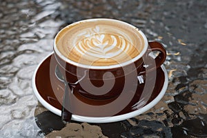 Hot coffee latte with beautiful latte art on ceramic glass in lo