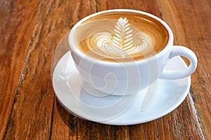 Hot coffee latte cappuccino cup with beautiful `rosetta` latte a