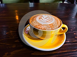 hot coffee latte with froth art on top