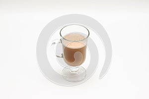 Hot coffee with milk and froth in a transparent glass cup on a white background studio photo