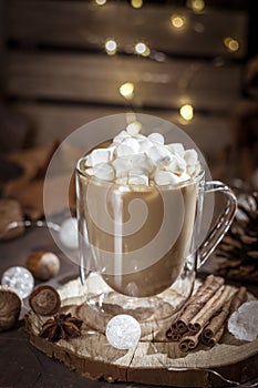 Hot coffee with milk in transparent glass with marshmallow