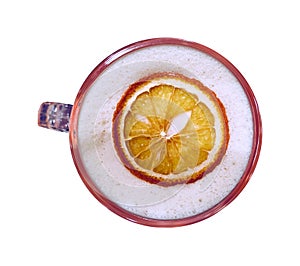 Hot coffee mug with slice of dried lime on white foam