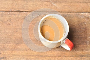 Hot coffee on old wooden plank
