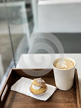 Hot coffee in paper cup and Choux Cream