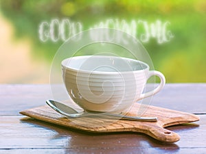 Hot coffee with smoke of good morning wording on wooden saucer a