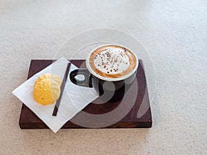 Hot coffee and sweets on table with morning sunshine