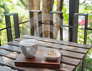 Hot coffee and sweets on table with morning sunshine