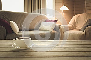 Hot coffee on tabletop in modern living room in rustic style. Blurred abstract background for design.