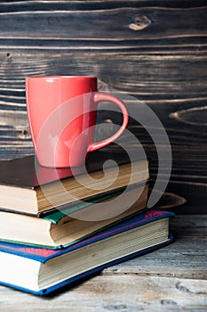 Hot coffee or tea, cocoa, chocolate cup on books