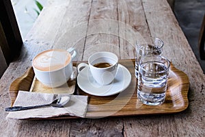 Hot coffee , tea, water order  serve set in  tray on the table background
