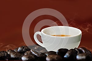 Hot coffee in a white coffee cup and many coffee beans placed around on wooden table