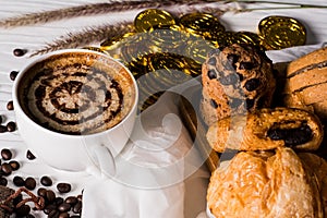 Hot coffee in white cup, with bakery, placed on white wood table, With sunshine in morning,Beauty concept of beverage and food