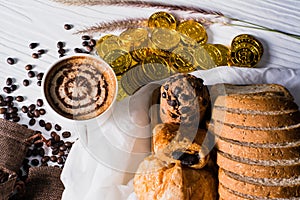 Hot coffee in white cup, with bakery, placed on white wood table, With sunshine in morning,Beauty concept of beverage and food