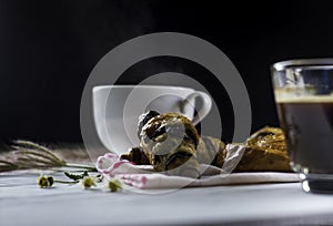 Hot coffee white cup ,with bakery placed on white wood table,With sunshine in morning, beauty concept of beverage,food with