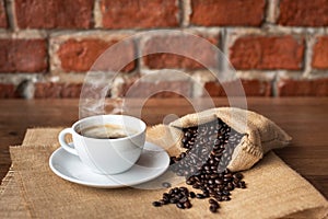 Hot coffee in white cup and roasted coffee beans