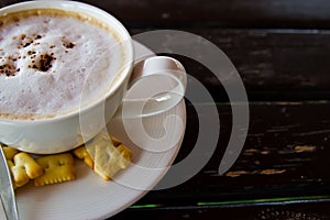 Hot coffee on wooden table