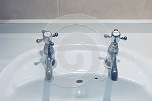Hot and cold taps in bathroom