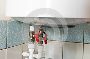 Hot and cold water taps on electric water heating boiler