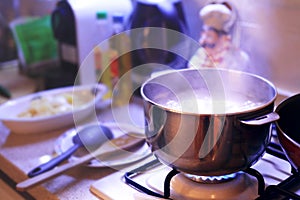 Hot cooking pot boiling on the stove in a cozy home like environment